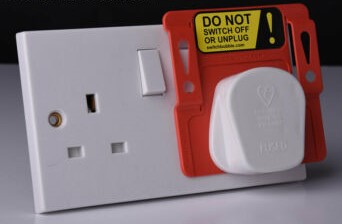 UK Plug in a socket marked Do Not Unplug